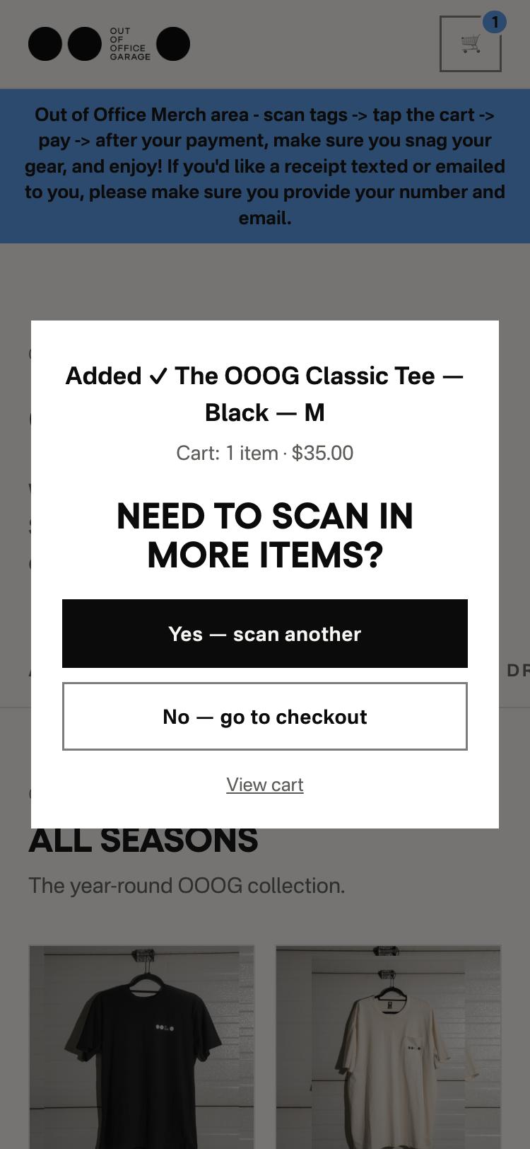 The store on a phone after a scan: the booth message at the top, and a prompt saying the Classic Tee in black, medium, was added, asking whether to scan more items, with Yes scan another, No go to checkout and View cart buttons.